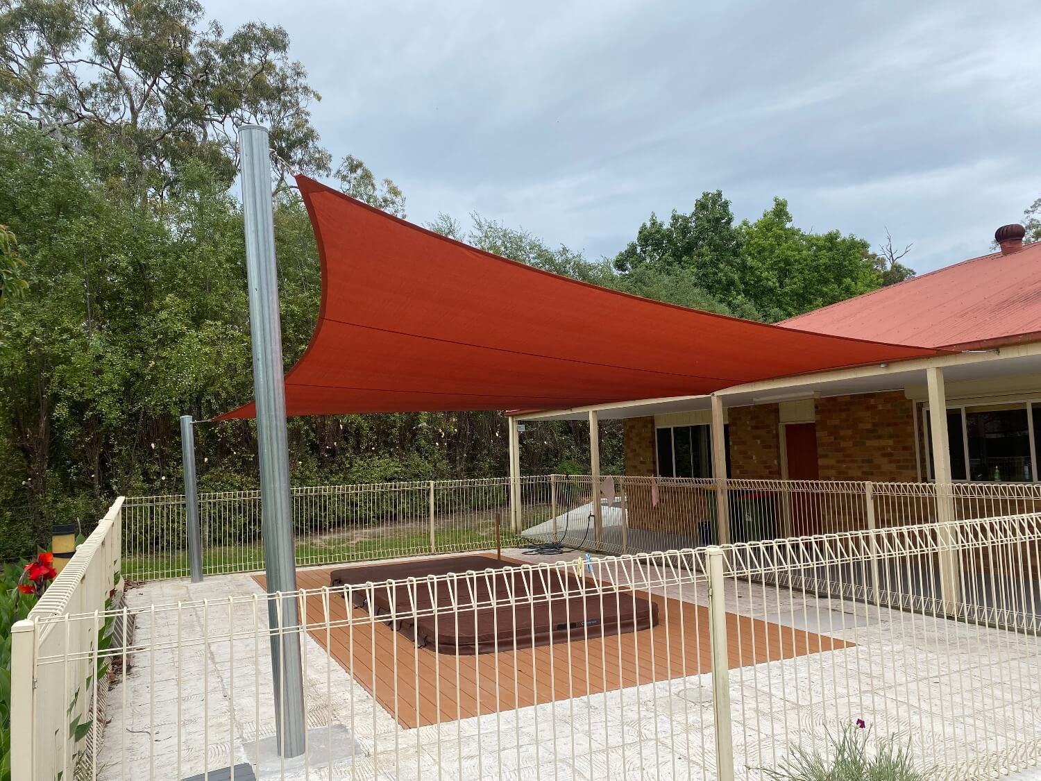 1x shade sail over outdoor pool / spa area. large shade sail.