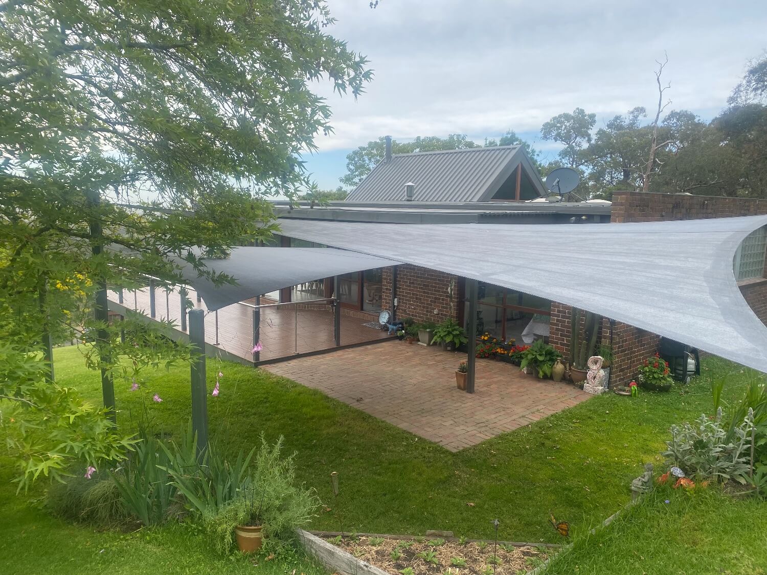 Two grey shade sails with powder coated posts